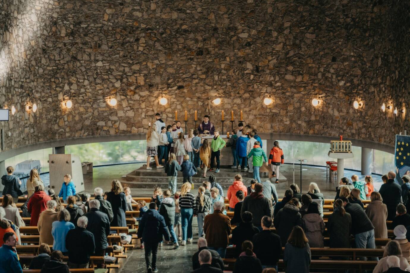 Kinder und Erwachsene in einer Kirche beim Gottesdienst